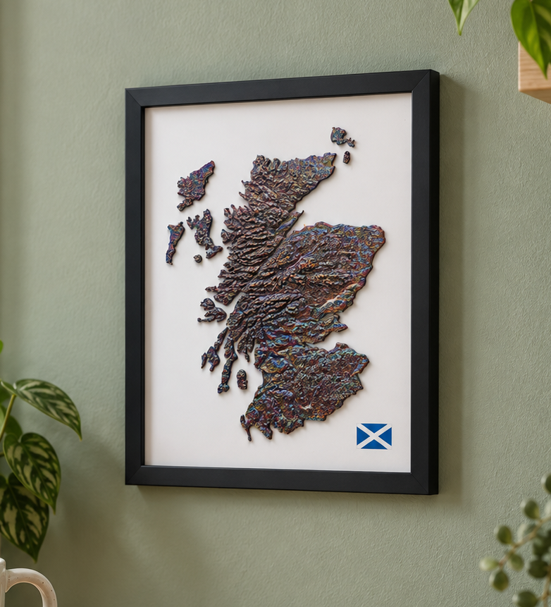 Iridescent relief map of Scotland in a black frame on a green wall